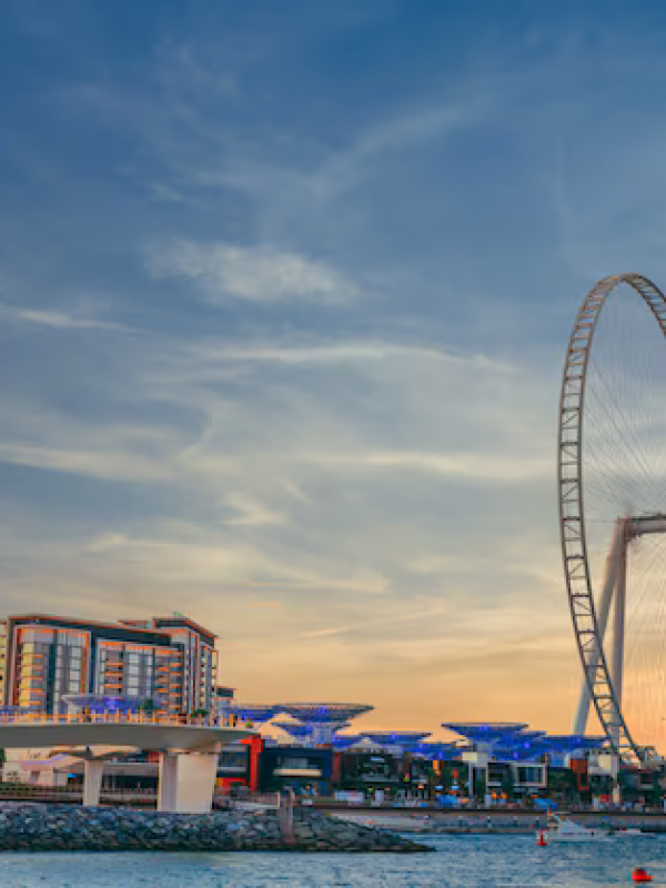 low-angle-shot-modern-design-building-with-huge-ferris-wheel-bluewaters-island-dubai_181624-25722